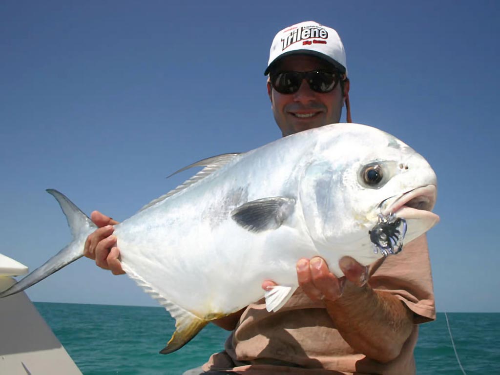 Image of angler holding a Permit caught on the fly in Key West