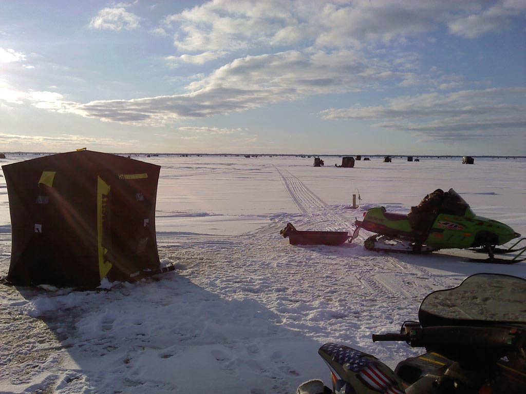 A morning shot of ice shanties and snow mobiles on the frozen Saginaw Bay in Michigan.
