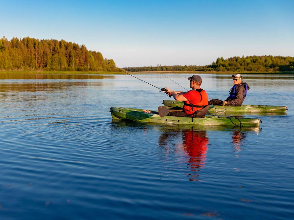 Two men kayak fishing in the Great Lakes