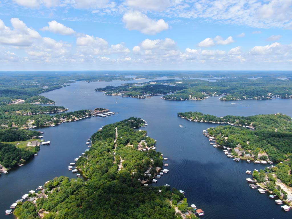 An aerial view of the meandering Lake of the Ozarks in Missouri and its dragon-shaped part, with greenery all around blue waters