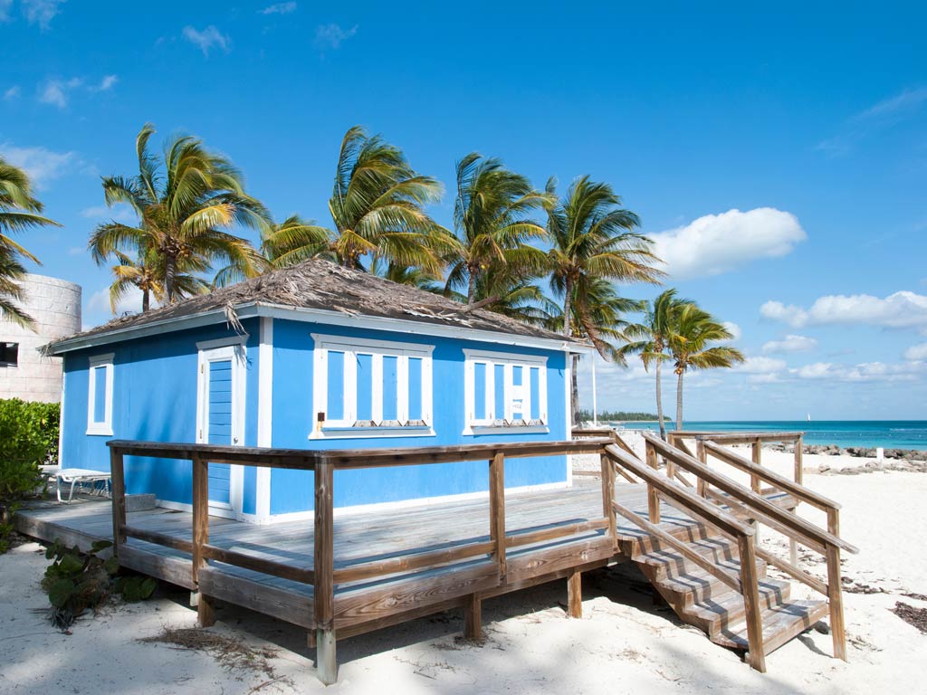 A photo of a blue beach house taken in Lucaya Beach in Freeport in the Bahamas on a bright spring day