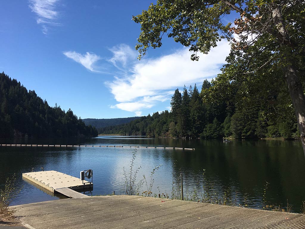 A view across a boat landing of Loch Lomond, a freshwater fishing haven near Santa Cruz, CA, on a clear day