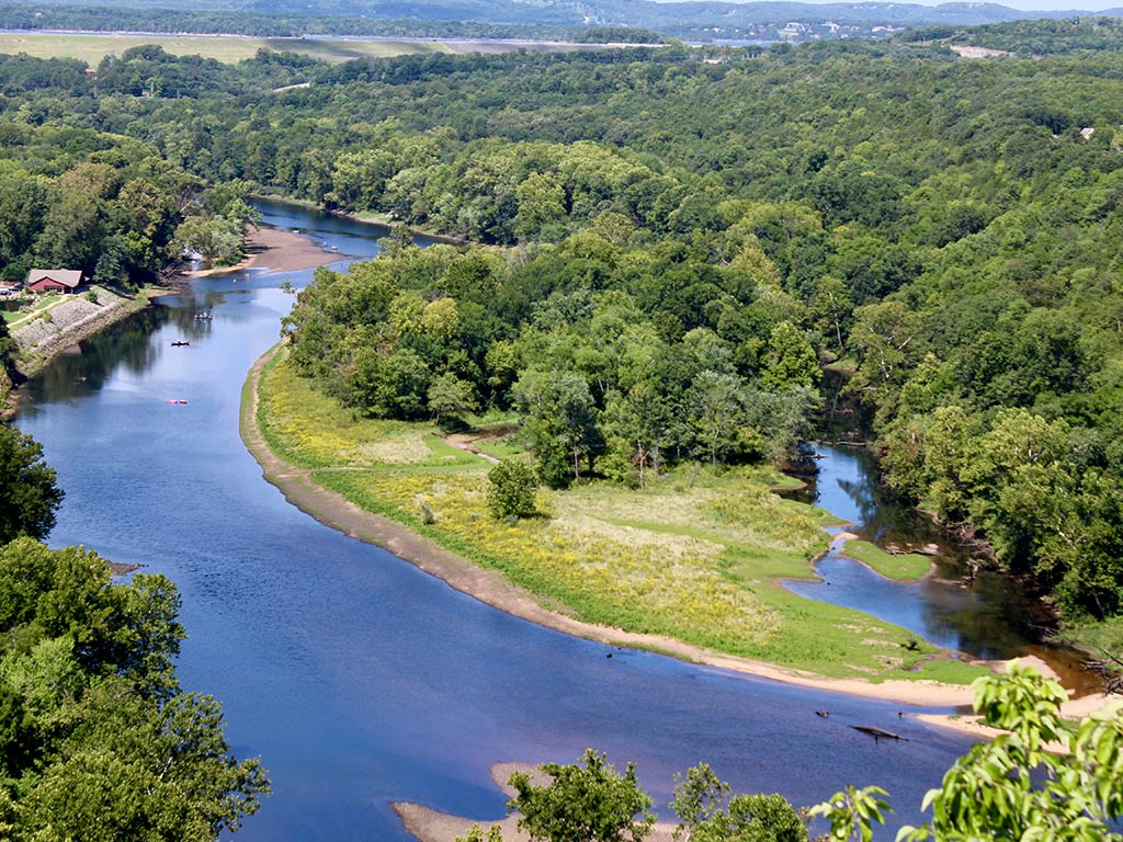 An aerial view of a bend in Table Fork Lake, with plenty of greenery on either side on a sunny summer's day