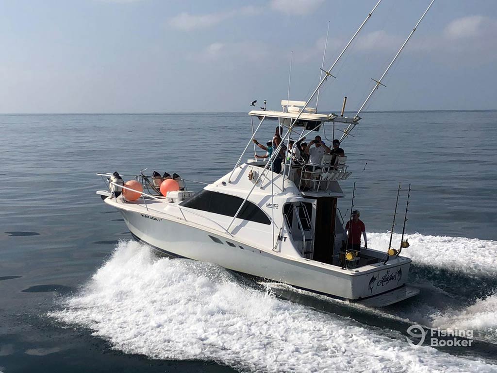 A view from above of an offshore sportfishing boat setting out towards the deep waters of the Atlantic from the Algarve on a day with sunny intervals