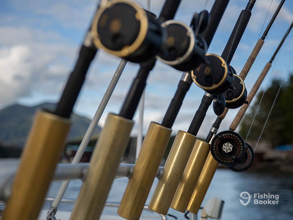 A closeup of the reels and handles of several trolling rods set up on a fishing boat in Ucluelet