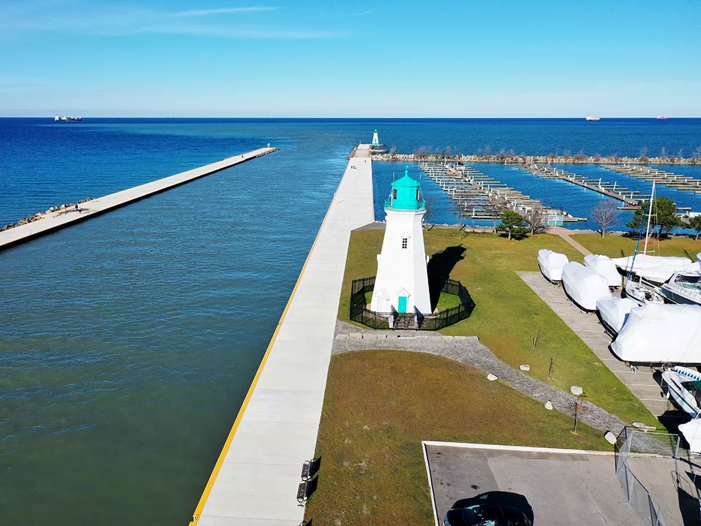 An aerial view of Port Dalhousie lighthouse in St. Catharines, Ontario, with a channel visible to the left of the image and land visible on the right