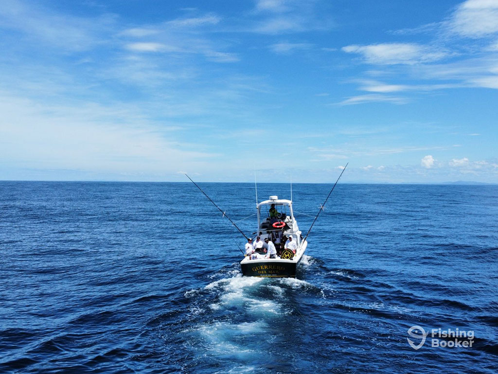 An aerial view across the water towards an offshore sportfishing boat in the deep waters of Costa Rica on a clear day