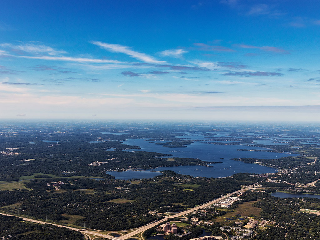 An aerial view of Lake Minnetonka on a clear day, with numerous islands visible in the water