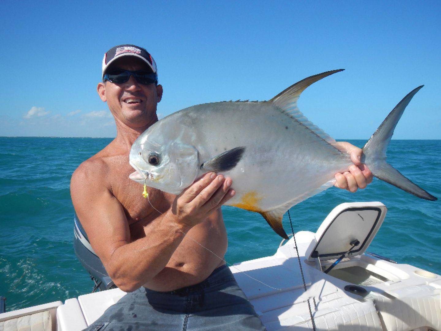 A man holding a Permit on a boat in Key Largo, Florida