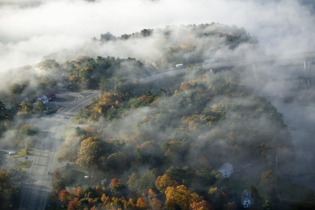 An aerial shot of fog over the town of Bath, Maine