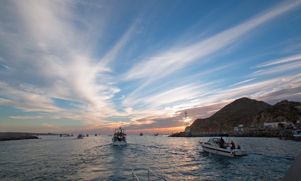 łodzie rybackie w Cabo San Lucas, wypływające w morze o wschodzie słońca