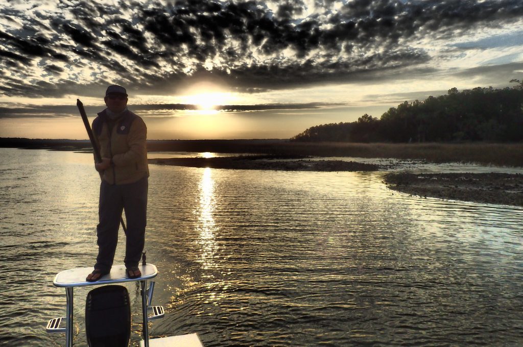 A charter captain poling along the flats near Charleston