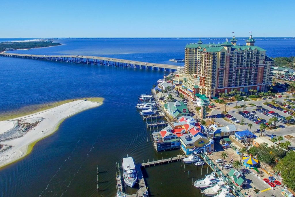 An aerial view of Destin, FL's cityscape, showing the Gulf to the left