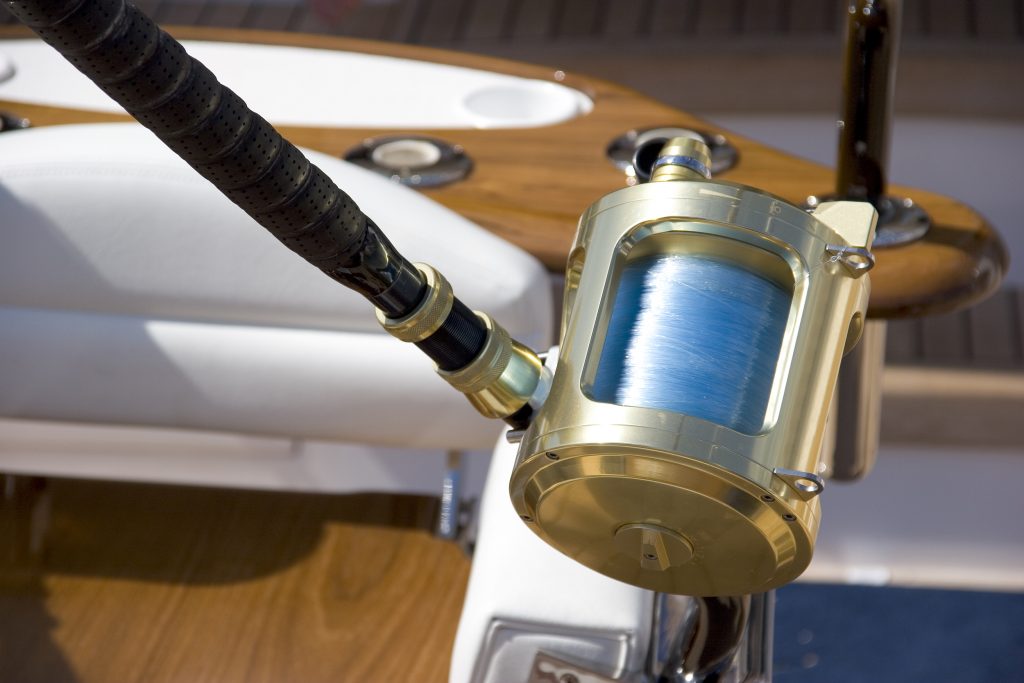 A heavy tackle trolling reel rigged with fluorocarbon line on a boat