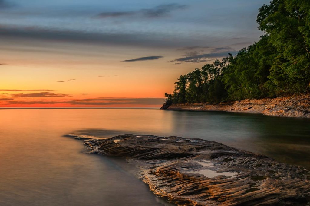 A view of Lake Michigan's shoreline at sunset.