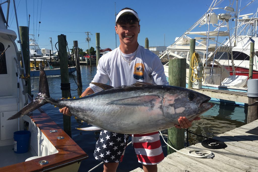 A happy angler holding a Bluefin Tuna caught out of Hatteras, NC