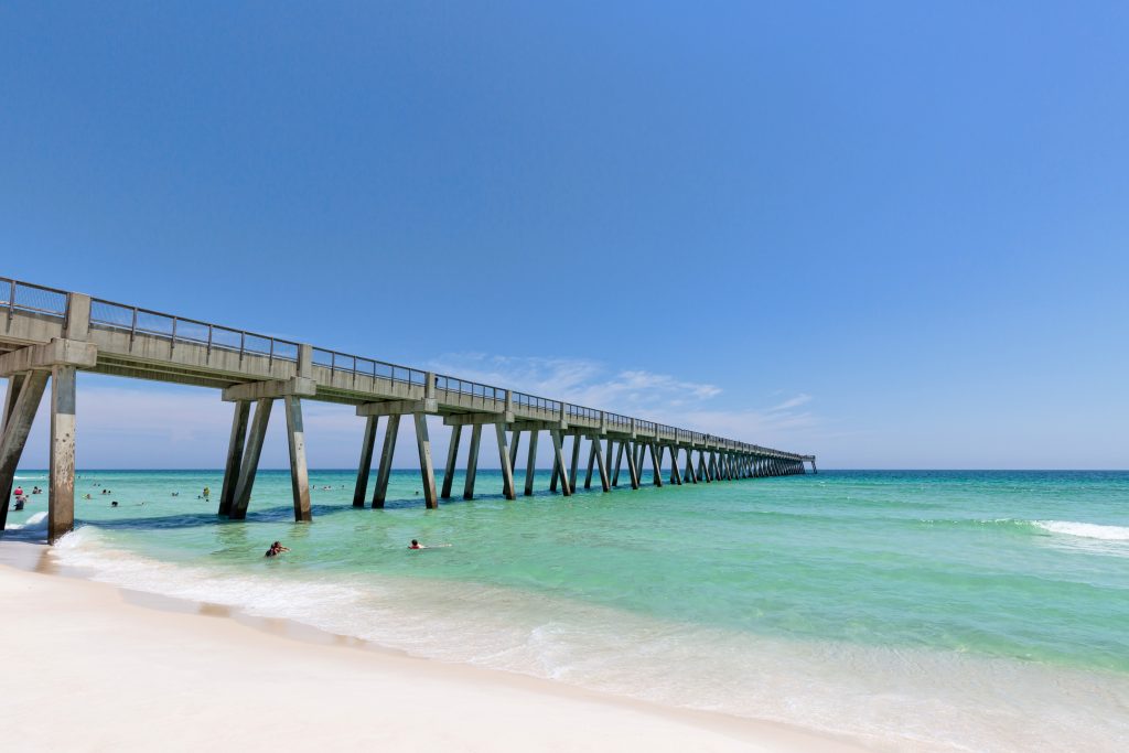 Pensacola Beach Gulf Fishing Pier stretching into the sea, as seen from the beach