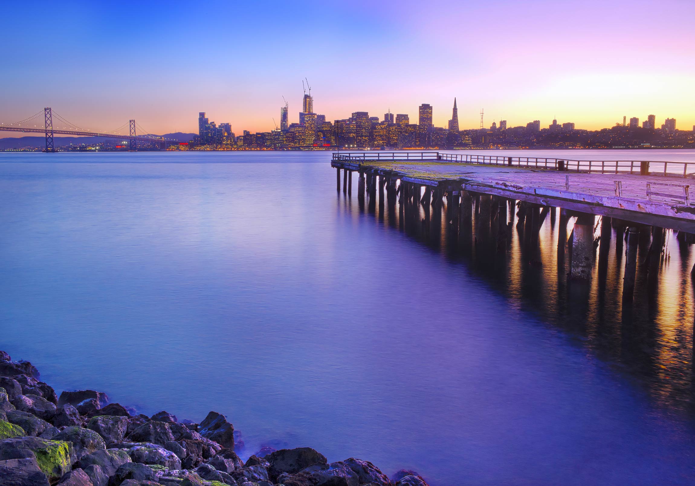 San Francisco pier after sunset with a city panorama in the distance