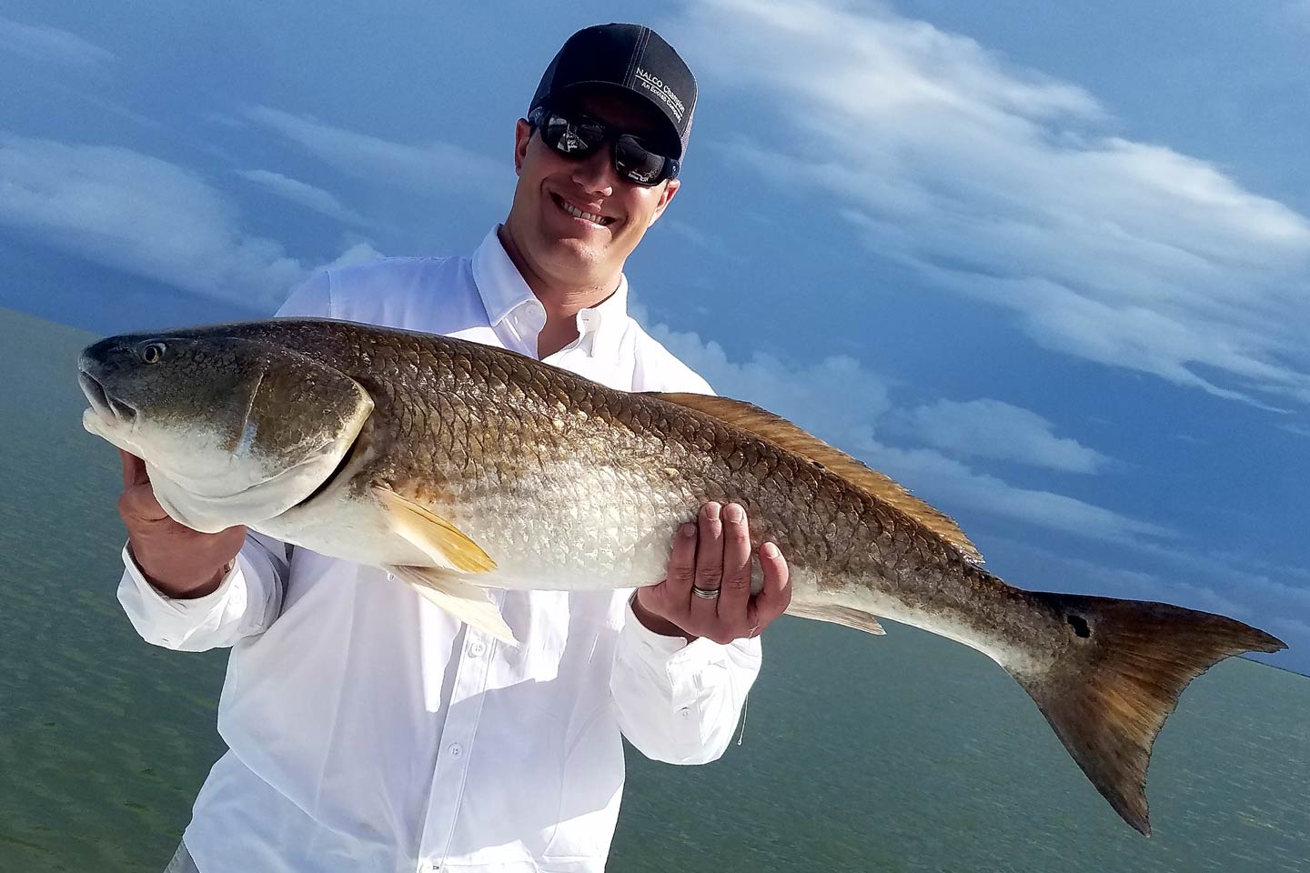 A man holding a Redfish on a boat in Florida