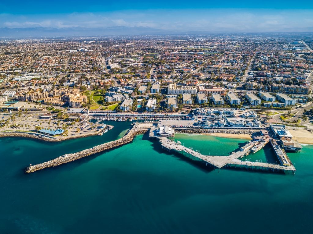 an aerial view of Redondo Beach pier and the town in the background