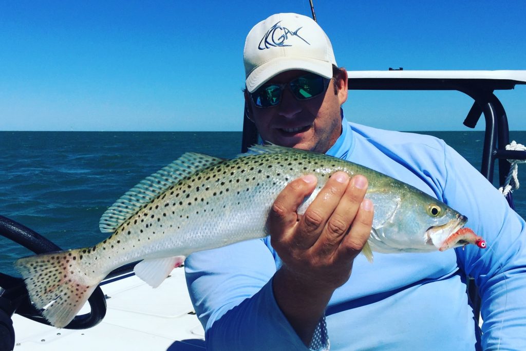 Male angler holding large Spotted Seatrout