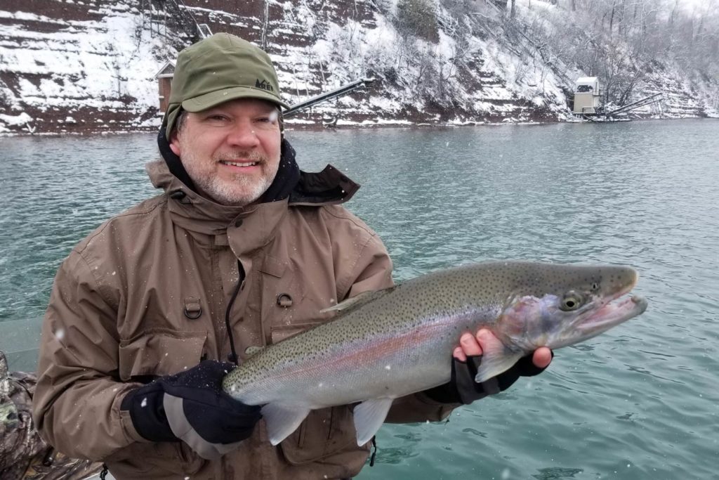 A male angler showing off a Steelhead caught during the winter run.