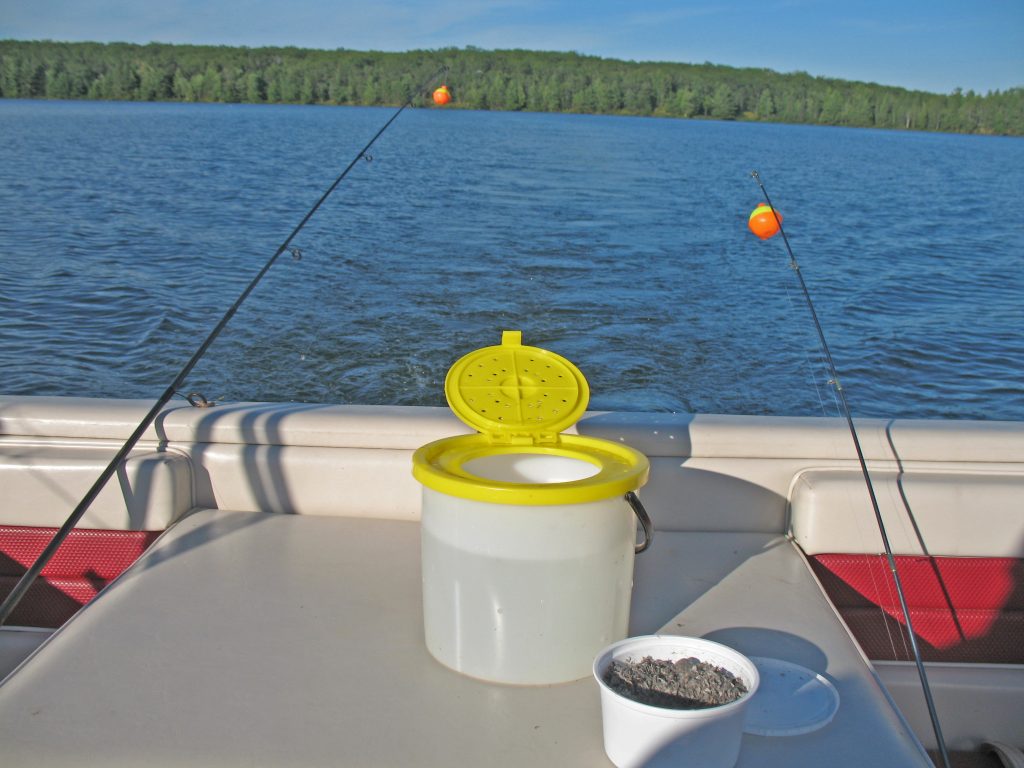 a bait bucket and some chum on a fishing boat