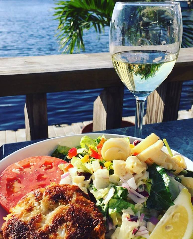 crab cake salad and a glass of white wine in coconut restaurant fort lauderdale