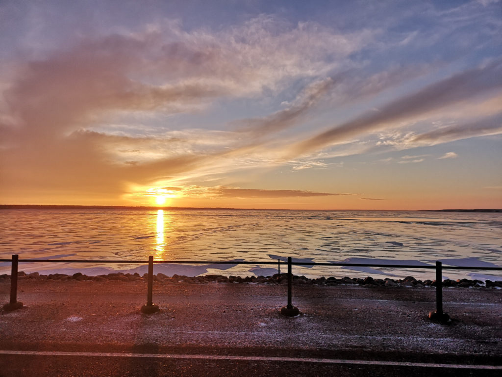 A sunset over the frozen Lake Diefenbaker, one of top ice fishing destinations in Canada