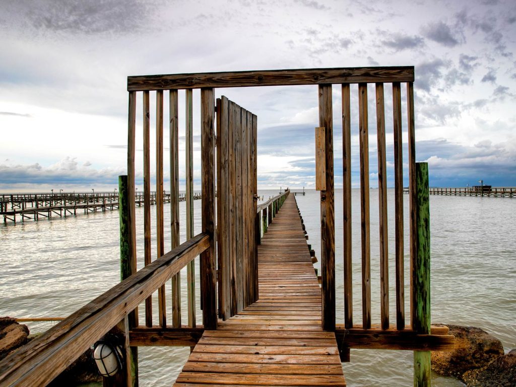 A wooden fishing pier in Port Mansfield, Texas